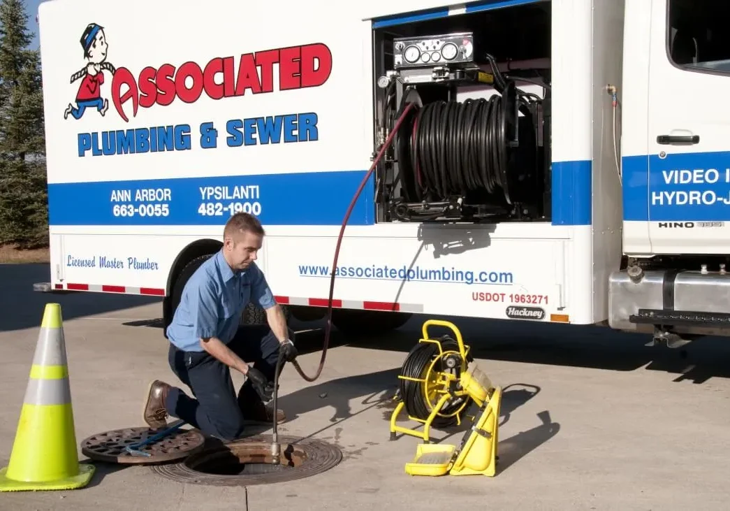 Plumber by manhole