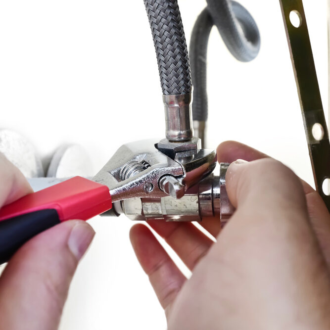 Hands,Hold,Wrench,To,Attach,And,Tighten,Water,Supply,Pipe
